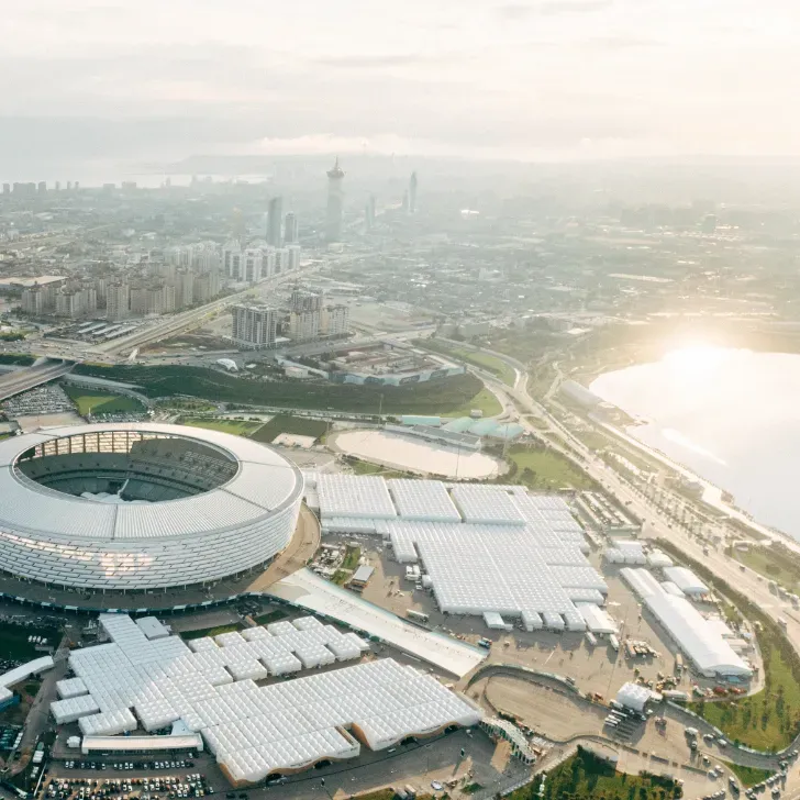 Modern cityscape with round building and cloudy skyline